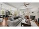 Open living room with a fireplace, hardwood floors, and seamless flow to the dining area at 101 Rustic Pine Ct, Apex, NC 27502