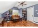 Cozy bonus room with hardwood floors, a comfortable couch, and built-in bookshelves at 101 Rustic Pine Ct, Apex, NC 27502