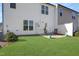Backyard featuring a cozy patio with seating, lush green grass, and a privacy fence at 1016 Mirbeck Ln, Durham, NC 27713