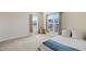 Bright bedroom featuring plush carpet, two windows, and a white comforter at 1016 Mirbeck Ln, Durham, NC 27713