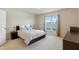 Bright bedroom featuring plush carpet, a window, and a modern lamp at 1016 Mirbeck Ln, Durham, NC 27713