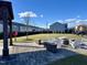Community outdoor space includes a brick patio with built-in fire pit, chairs, and views of the lawn at 1016 Mirbeck Ln, Durham, NC 27713