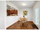 Light filled dining room adjacent to kitchen with table and chairs plus decorative painting at 1016 Mirbeck Ln, Durham, NC 27713