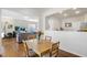 Cozy dining area with wood table and seating, seamlessly connected to the living room and kitchen at 1016 Mirbeck Ln, Durham, NC 27713