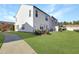 Exterior side view shows a lush lawn and a private fenced-in patio with ample outdoor space at 1016 Mirbeck Ln, Durham, NC 27713