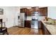 Modern kitchen with stainless steel appliances, granite countertops, and ample cabinet space at 1016 Mirbeck Ln, Durham, NC 27713