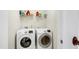 Well-equipped laundry room features modern appliances and ample shelving at 1016 Mirbeck Ln, Durham, NC 27713