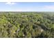 Expansive aerial view of the property showcasing lush trees and the surrounding landscape on a clear day at 104 Arcadia Ln, Chapel Hill, NC 27514