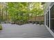View of the expansive back deck surrounded by a beautiful wooded area at 104 Arcadia Ln, Chapel Hill, NC 27514