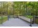A view of back deck featuring gray decking, gray railings, and planters at 104 Arcadia Ln, Chapel Hill, NC 27514