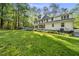 Expansive backyard featuring lush green grass and a view of the home's exterior at 104 Arcadia Ln, Chapel Hill, NC 27514