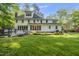 Expansive backyard features a lush lawn and view of the home's rear elevation with a deck at 104 Arcadia Ln, Chapel Hill, NC 27514