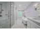 Bright bathroom with a glass shower, bathtub, and marble floors at 104 Arcadia Ln, Chapel Hill, NC 27514