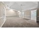 Spacious primary bedroom with neutral carpet, tray ceiling, and ensuite access at 104 Arcadia Ln, Chapel Hill, NC 27514