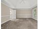 Bright bedroom with a ceiling fan, and ensuite bathroom with a large window at 104 Arcadia Ln, Chapel Hill, NC 27514