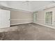 Bright bedroom with vaulted ceiling, two windows, and neutral carpet flooring at 104 Arcadia Ln, Chapel Hill, NC 27514