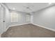 Well-lit bedroom offers plush carpeting and two windows for plenty of natural light at 104 Arcadia Ln, Chapel Hill, NC 27514