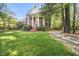 Charming brick home with a well-manicured lawn and a stone pathway leading to a tranquil garden at 104 Arcadia Ln, Chapel Hill, NC 27514