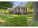 Stately brick home with white columns, lush lawn, and mature trees creating a picturesque setting at 104 Arcadia Ln, Chapel Hill, NC 27514