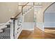 Elegant foyer with hardwood floors, staircase, and archway creating a welcoming entrance at 104 Arcadia Ln, Chapel Hill, NC 27514