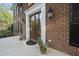 Elegant brick home featuring a stately front door with sidelights and decorative lighting fixtures at 104 Arcadia Ln, Chapel Hill, NC 27514