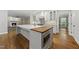 Modern kitchen with white cabinetry, large island, and stainless steel appliances at 104 Arcadia Ln, Chapel Hill, NC 27514
