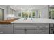 Kitchen island sink with butcher block and quartz countertops and bright natural lighting at 104 Arcadia Ln, Chapel Hill, NC 27514