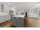 Expansive kitchen with hardwood floors, stainless steel appliances, and a large center island at 104 Arcadia Ln, Chapel Hill, NC 27514