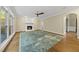 Inviting living room with fireplace, bright windows, and hardwood floors with a large rug at 104 Arcadia Ln, Chapel Hill, NC 27514