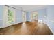 This spacious living room offers wood floors, large windows with white drapes, and neutral paint at 104 Arcadia Ln, Chapel Hill, NC 27514