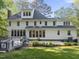 Back exterior of home with many windows, nice yard, and lovely deck at 104 Arcadia Ln, Chapel Hill, NC 27514