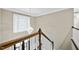 Staircase with wood railing and decorative chandelier overhead providing soft lighting at 104 Arcadia Ln, Chapel Hill, NC 27514