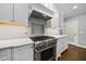 Modern stainless steel stove with a stylish backsplash and white cabinets for ample storage at 104 Arcadia Ln, Chapel Hill, NC 27514