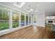 Bright sunroom featuring hardwood floors, large windows, and a skylight for natural light at 104 Arcadia Ln, Chapel Hill, NC 27514