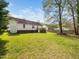 This backyard features a well-maintained lawn, a charming deck, and a home with a door leading to outside at 104 Hamby Ct, Garner, NC 27529