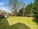 Expansive backyard featuring a lush lawn, mature trees, and a spacious deck perfect for outdoor enjoyment at 104 Hamby Ct, Garner, NC 27529