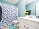 Cozy bathroom featuring a white vanity with ample storage and floral shower curtain at 104 Hamby Ct, Garner, NC 27529