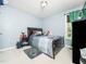 Neutrally decorated bedroom, featuring a dark wood bed frame, gray carpet, and an exterior view at 104 Hamby Ct, Garner, NC 27529