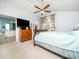 Well-lit bedroom with ceiling fan, large TV, ensuite bathroom, and a cozy feel at 104 Hamby Ct, Garner, NC 27529