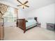 Bright bedroom with a ceiling fan, neutral carpet, and large window creating a calm atmosphere at 104 Hamby Ct, Garner, NC 27529