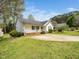 Well-maintained single-story home with a front porch, green lawn, and mature trees adding curb appeal at 104 Hamby Ct, Garner, NC 27529