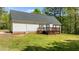 A backyard featuring a wooden deck and well maintained lawn at 105 Coral Ridge Cir, Franklinton, NC 27525