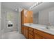 Bathroom featuring dual sinks, vanity with cabinets and drawers, large mirror and window for light at 105 Coral Ridge Cir, Franklinton, NC 27525