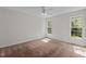 Sun-filled bedroom features carpet, neutral walls and two large windows for great natural light at 105 Coral Ridge Cir, Franklinton, NC 27525