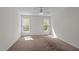 Carpeted bedroom featuring two windows that fill the room with natural light and a ceiling fan at 105 Coral Ridge Cir, Franklinton, NC 27525