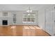 Dining area with natural light and hardwood floors next to a fireplace and door leading to deck at 105 Coral Ridge Cir, Franklinton, NC 27525