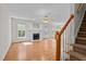 Bright living room featuring hardwood floors, a fireplace, and multiple windows allowing natural light at 105 Coral Ridge Cir, Franklinton, NC 27525