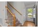 Inviting staircase with hardwood treads, white risers, and a wood handrail leading upstairs at 105 Coral Ridge Cir, Franklinton, NC 27525
