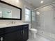 Bright bathroom featuring modern shower, stylish vanity with black cabinets, and natural light at 108 Clements Dr, Morrisville, NC 27560