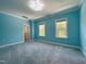 Light blue bedroom offers large windows, plush carpet, and bright recessed lighting at 108 Clements Dr, Morrisville, NC 27560